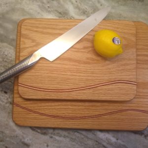 The Wave: Oak cutting board with maple and padauk accents